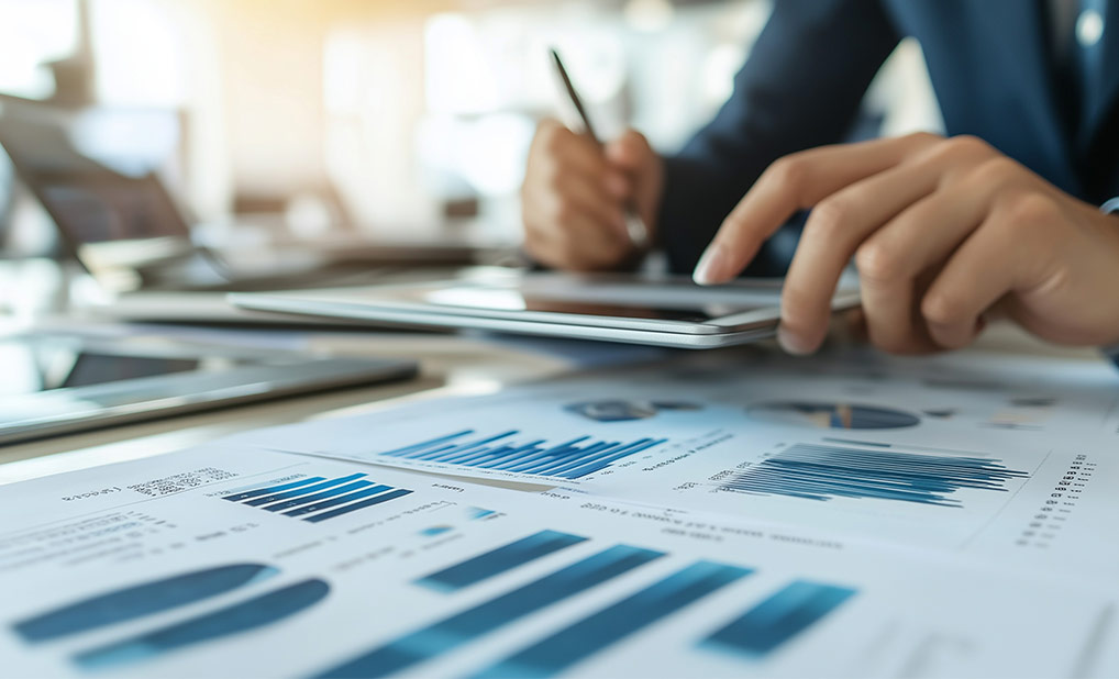 Close up of hands at desk with financial documents