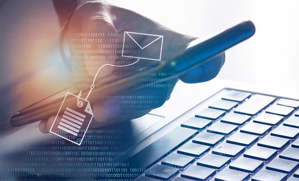 Close up of person using laptop with overlay illustration of email