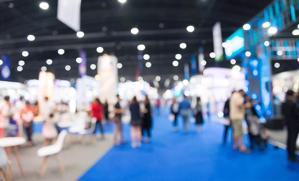 Abstract image of people in conference exhibit hall