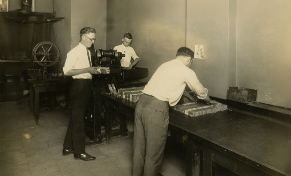 Individuals from the 1920s working on a cash processing operation