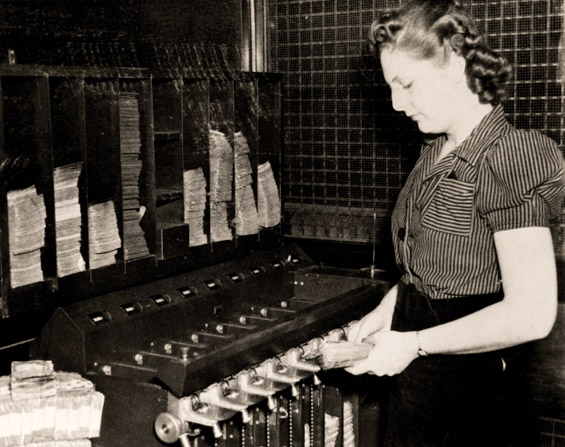 Historical photo of sorting cash by hand