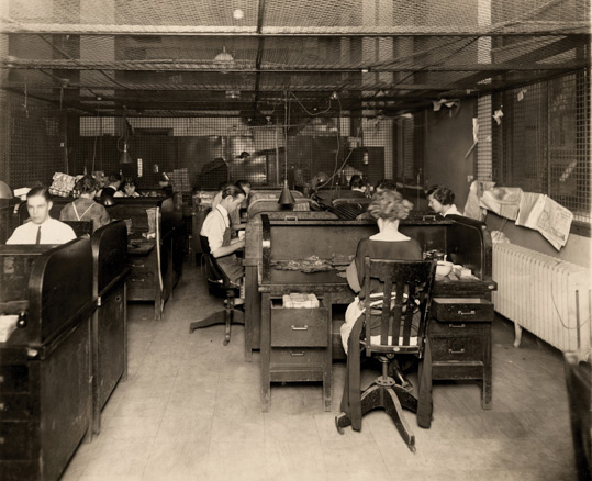 Historical photo of sorting cash by hand