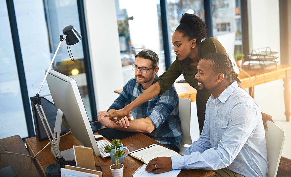 Group of people working on computer at office