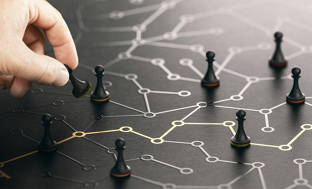 Person moving chess pieces on board with connected lines