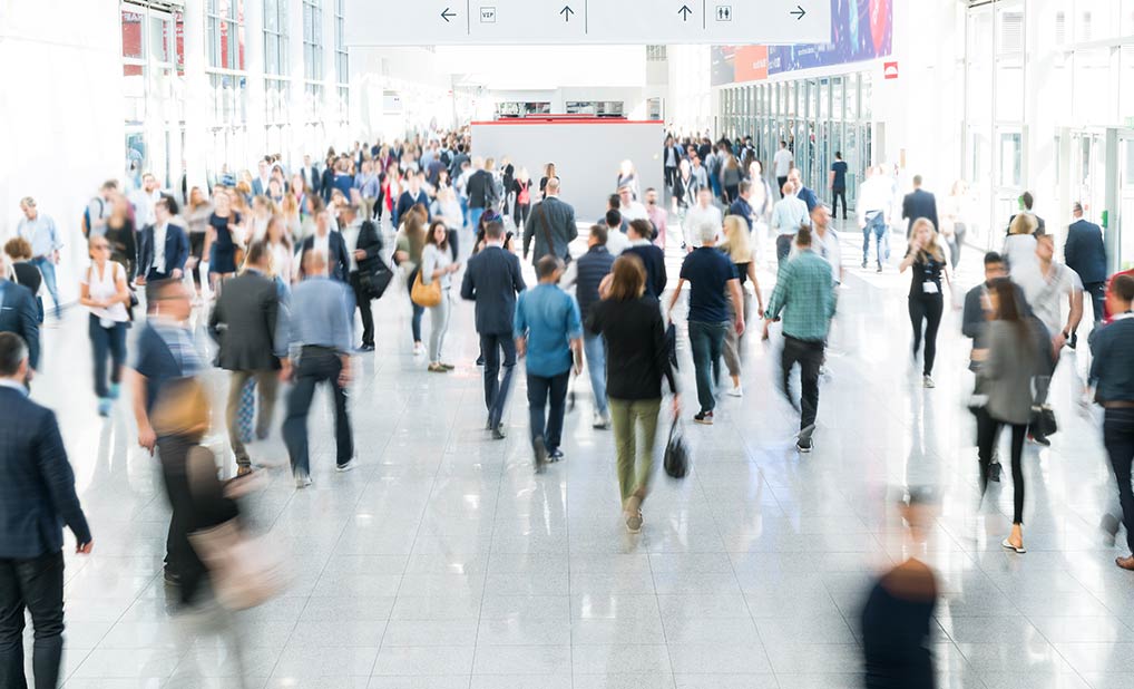Abstract image of people in large hallway