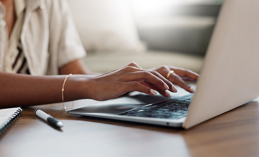 Close up of person typing on laptop