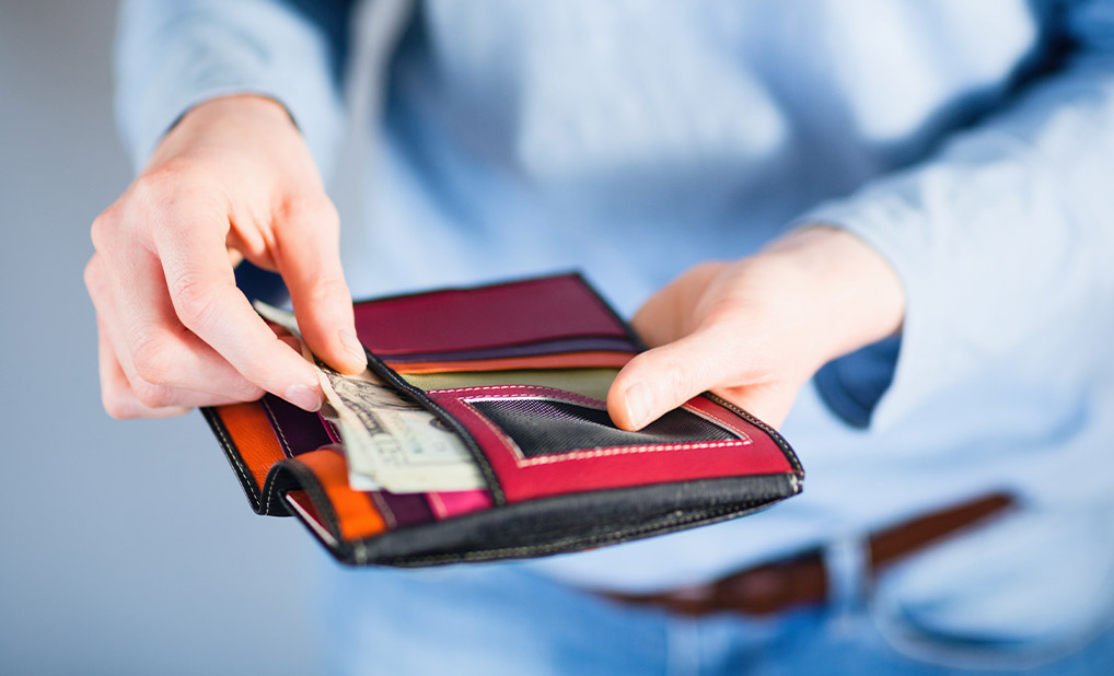Person pulling money out of wallet