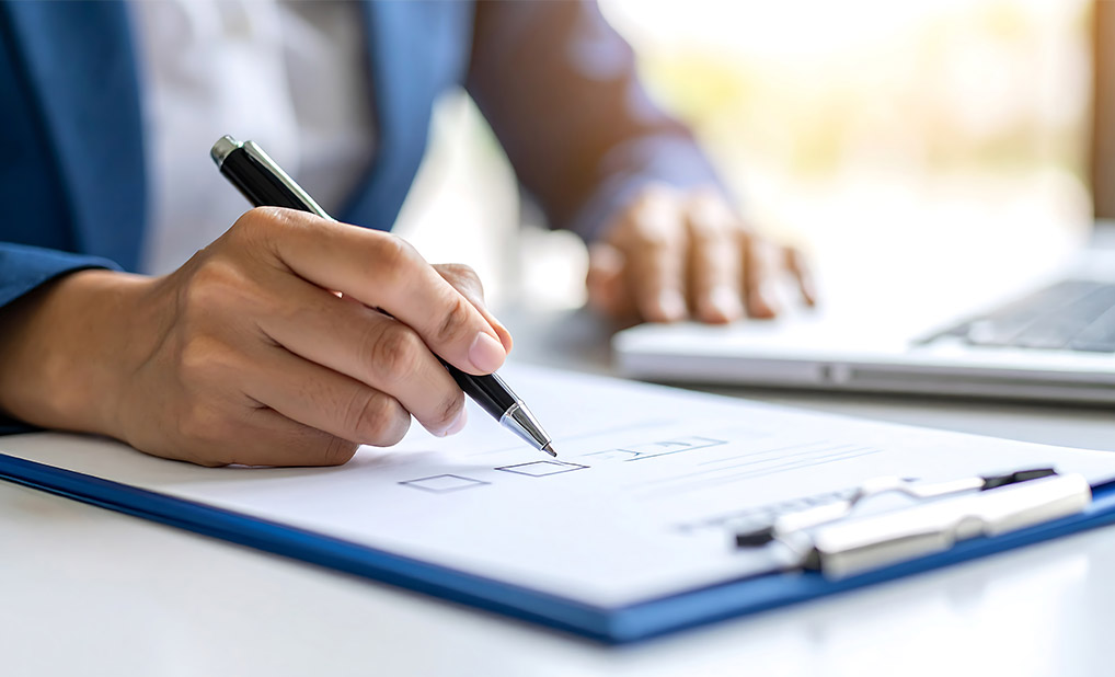 Close up of person signing checklist