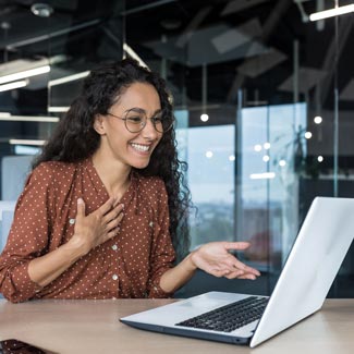 A woman communicating through her computer.