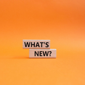 Wooden tiles saying 'What's new?' on an orange background