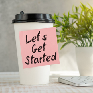 takeout coffee cup with a post-it note that says 'let's get started'