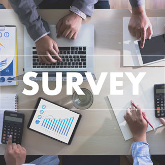 top down view of people meeting while typing, using calculators, and writing notes